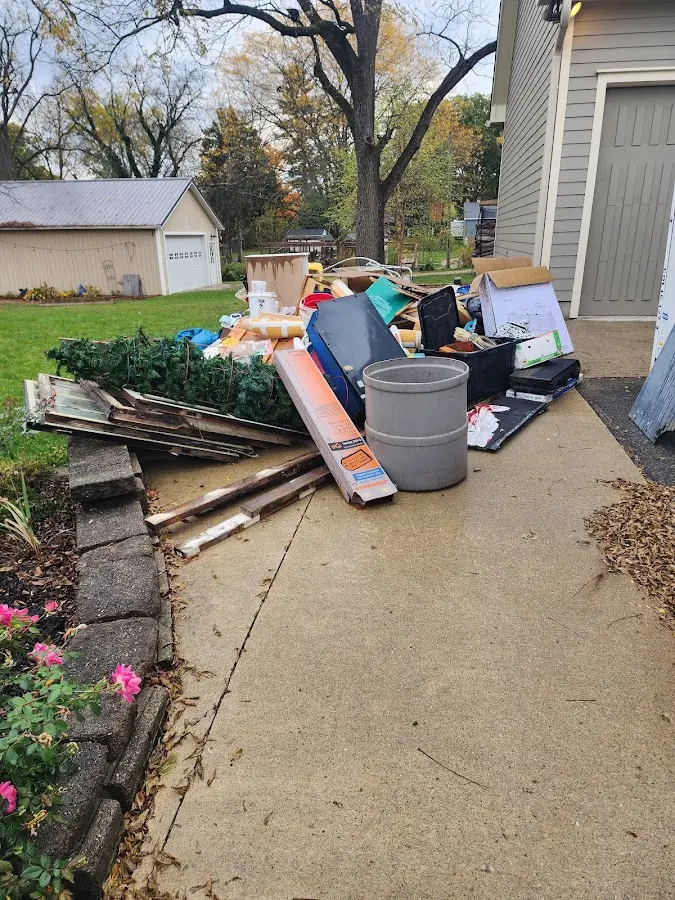 Dumpster being loaded with debris for Commercial Dumpster Rental in Newport